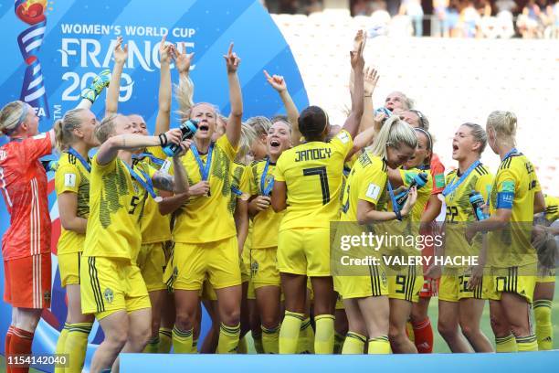 Sweden's players celebrate during the victory ceremony held at the end of the France 2019 Women's World Cup third place final football match between...