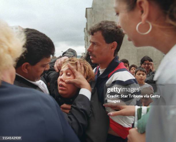 Chanov, Czech Republic. July 9, 1999. Roma Funeral. -- Relatives and friends tried to help a woman who had fainted during the funeral procession for...