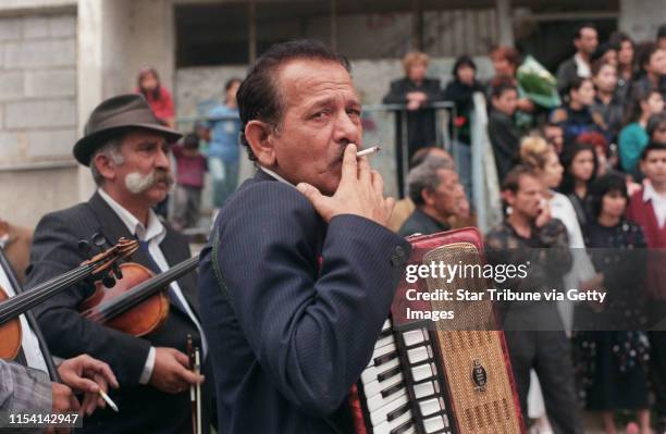 Chanov, Czech Republic. July 9, 1999. Roma Funeral. -- Mirek and Jan Rac take a cigarette break as they waited for the hearse to arrive at the...