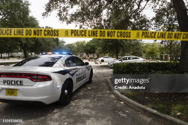 Police officers secure the area with police tape at the site after an explosion at Florida shopping plaza, on July 06, 2019 in Plantation, Florida,...