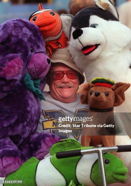 Through SEPTEMBER 4, 2000: IN THIS PHOTO: FAIRFACE: Eddy√≠s Teddyland is the first stop of the Fair for Gregg Asher of Mankato. He buys plush bears...