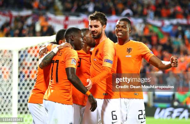 Quincy Promes of the Netherlands celebrates after scoring his team's third goal with Davy Propper and Denzel Dumfries and team mates during the UEFA...