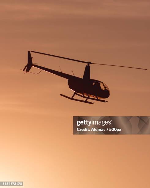 helicopter at sunset - elicottero stock pictures, royalty-free photos & images