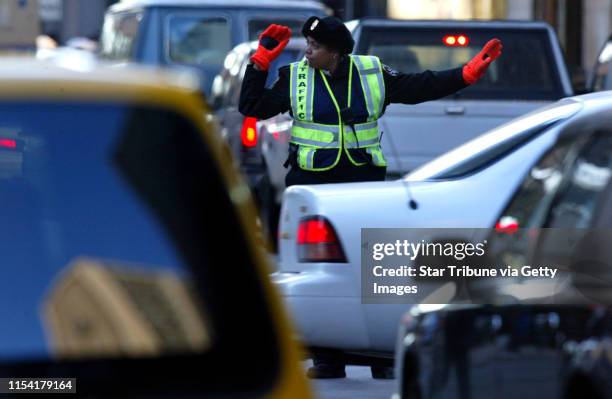 Minneapolis traffic patrol agent Paula Rangel direct the evening rush-hour traffic at the intersection of 7th and Marquette Ave. In downtown...