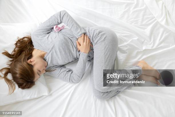 yoıung woman stomachache, feel pain - sports period stock pictures, royalty-free photos & images