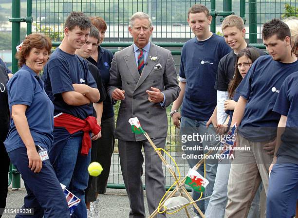 Prince Charles,Prince of Wales attempts a shot in a catapult game during a visit the Prince's Trust Cymru Activity Centre at Pembroke Dock on July 3,...