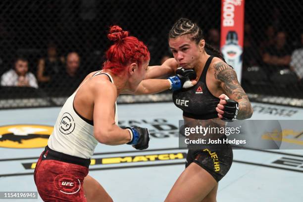Randa Markos of Canada and Claudia Gadelha of Brazil trade punches in their strawweight fight during the UFC 239 event at T-Mobile Arena on July 6,...
