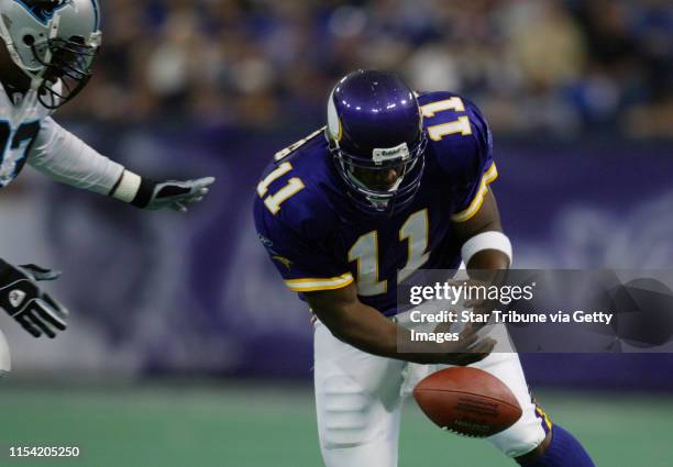 Minneapolis MN, 9/22/02 Vikings vs. Carolina--Vikings quarterback Daunte Culpepper fumbles the ball out of bounds as Carolina's defensive end Michael...