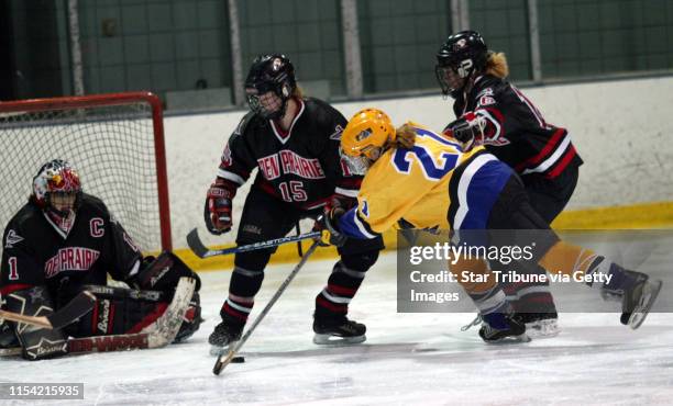 Minneapolis, MN - Chaska forward Kim McClintick just misses a shot into the goal as Eden prarie's Meaghan Pezon and Brittni Kuyper and goalie Kristin...