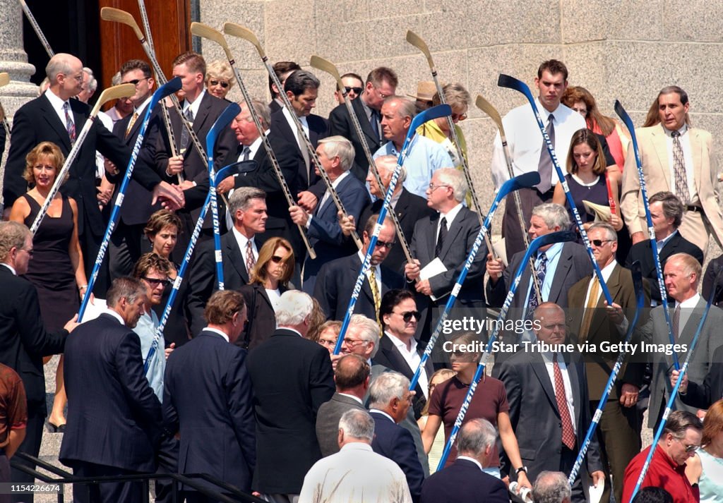 St. Paul, Mn., Sat., Aug. 16, 2003--Honorary pall bearers with hockey sticks line the steps of the Cathedral of St. Paul in preparation for the formation of a broken arch for the clergy, mourners and the pall bearers carrying the casket. (At lower right,