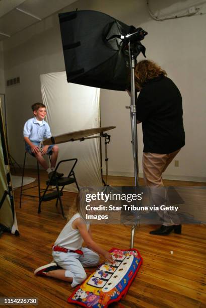 Photographer Joan Buccina, right, shoot head shots of eight-year-old A.J. LaPanta, who is relaxed in front of the camera and knows exactly when to...