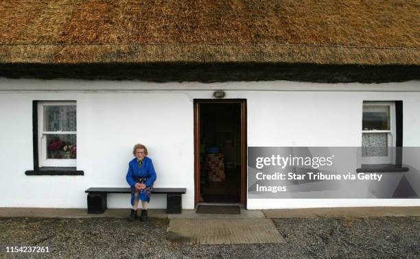 Eighty-four-year-old Lily Quinn sits in front of her thatched roof home in Bundoran, County Donegal. Quinn grew up in the home and will live there...