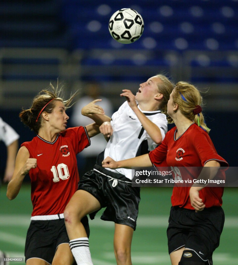 Minneapolis, MN., Monday, 10/27/2003. (left to right) Shakopee's Kelly Manske, Caledonia's Sarah Colleran and Shakopee's Sydney Cancelliere fought for control of the ball in second half action at the Class A girls soccer semifinal.