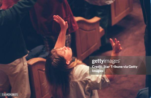 Pentecostal revival at the Brownsville Assembly of God. A woman raises her hands in prayer during the prayer service at the Brownsville Assembly of...