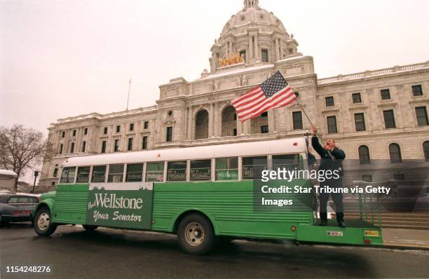 Paul Scott, the original green bus driver, takes the American flag down from the bus after a press conference at the State Capitol. The green bus...