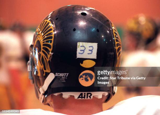 THE PLAYERS ON THE MAHTOMEDI FOOTBALL TEAM WEAR IOWA HAWKEYE DECALS AND THE NUMBER 33 IN MEMORY OF THE LATE JR. VARSITY COACH AL SANSGAARD.