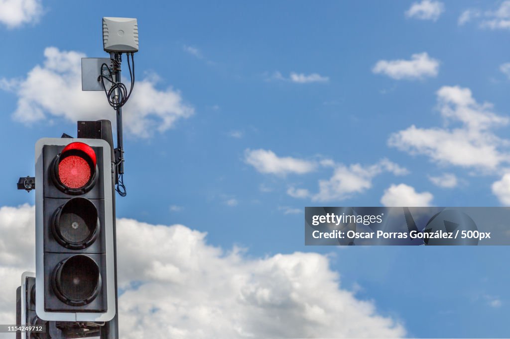 Traffic Light Illuminated In Red, With A Lovely Sky Background