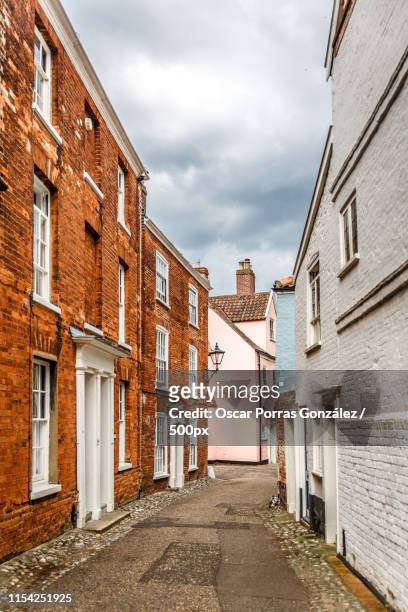 vertical view of a narrow street typical of a small english town - idyllic house stock pictures, royalty-free photos & images