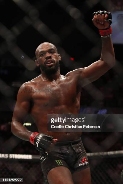 Jon Jones raises his hand at the end of his fight against Thiago Santos of Brazil in their UFC light heavyweight championship fight during the UFC...