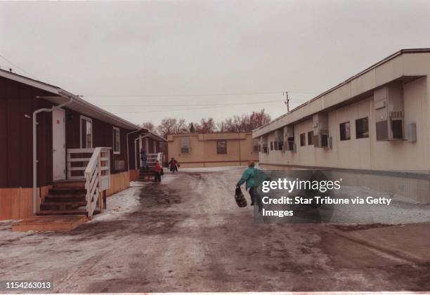 How has Grand Forks faired through the winter. -- Students run to the ìrelocatables' which make up Belmont Elementary School in Grand Forks. The...