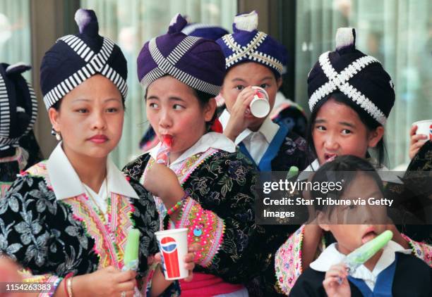 This is a kickoff parade for National Night Out, the night neighbors are supposed to band together and cast the criminals out. Hmong children dressed...