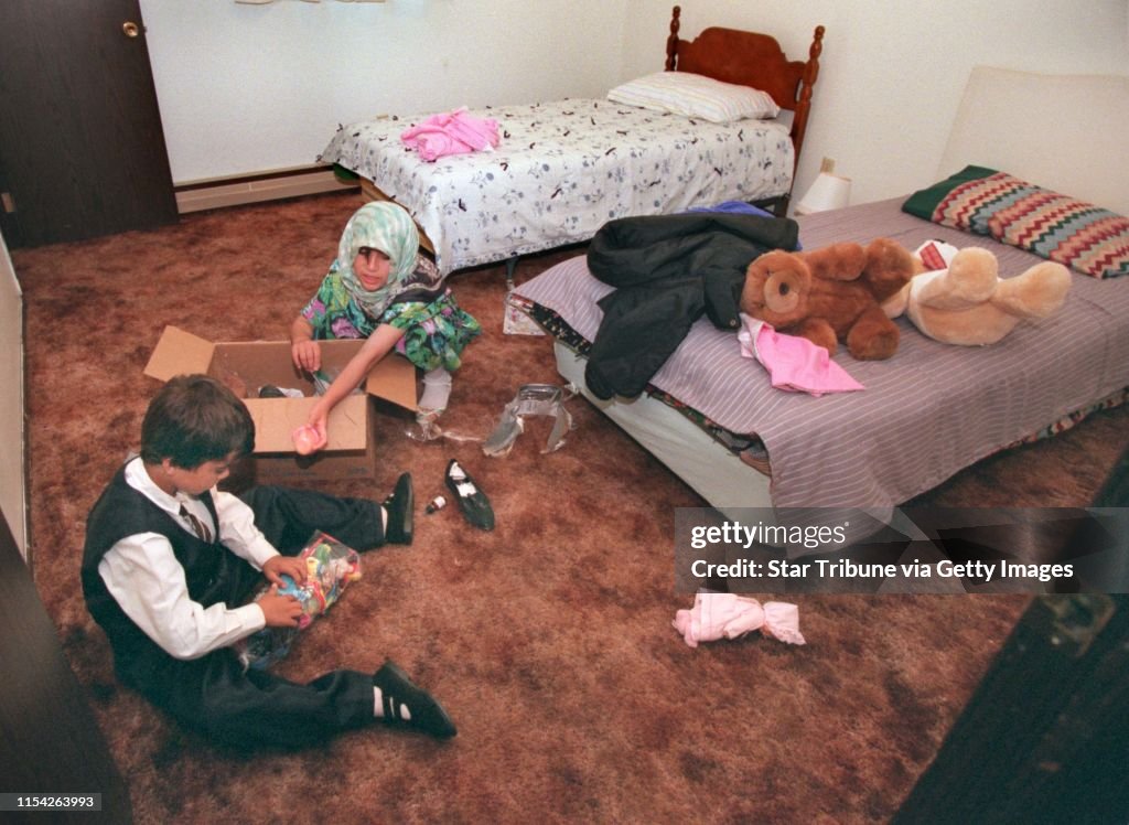 Once Gean and Guvar Jalal , children of Jamal Amin found their new bedroom , they anxiously unpacked the box of toys they brought with them from Guam and got busy playing.(Photo by RITA REED/Star Tribune via Getty Images)