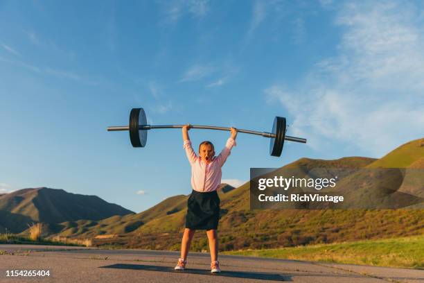 young girl businesswoman lifting weights - young kid and barbell stock pictures, royalty-free photos & images