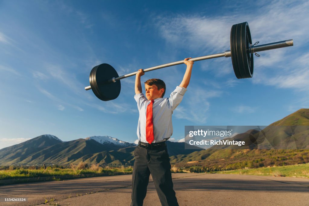 Young Boy Businessman Lifting Weights