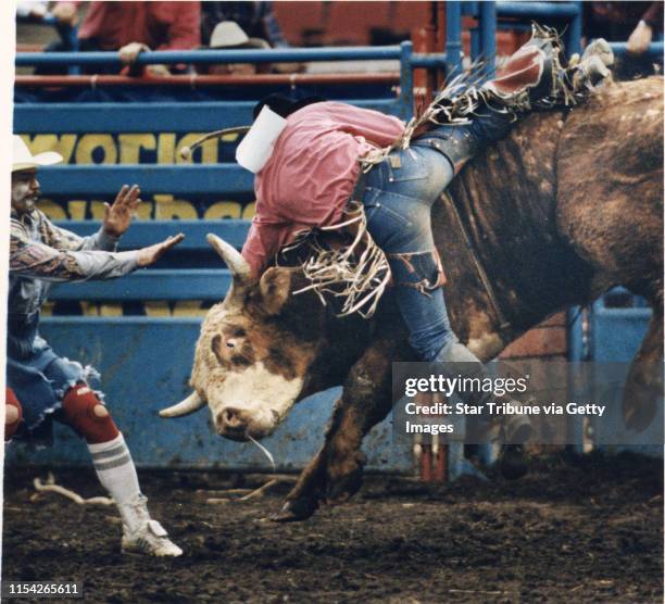 Rodeo Clown did his best to calm things down, while bronco bull rider Dan Plummer was thrown from the bulls back. Star Tribune photo Marlin Levison...