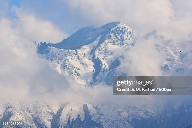 clouds around mystic mountain - srinagar stock pictures, royalty-free photos & images