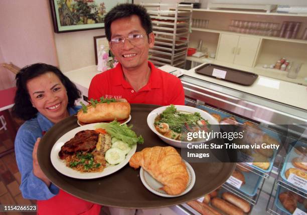 Tony Le and Edna Nguyen hold a selection off their menu. Clockwise from left: Com Tam Sudn Bi Cha ; Banh Mi Thit ; Mi Tom Cua and fresh croissant, 89...