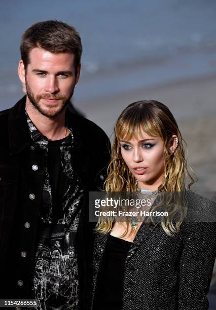 Liam Hemsworth and Miley Cyrus attend the Saint Laurent Mens Spring Summer 20 Show on June 06, 2019 in Paradise Cove Malibu, California.