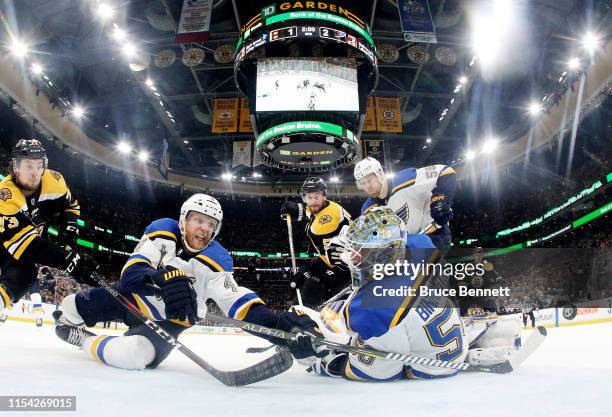 Carl Gunnarsson and Jordan Binnington of the St. Louis Blues defend the goal against the Boston Bruins during the third period in Game Five of the...