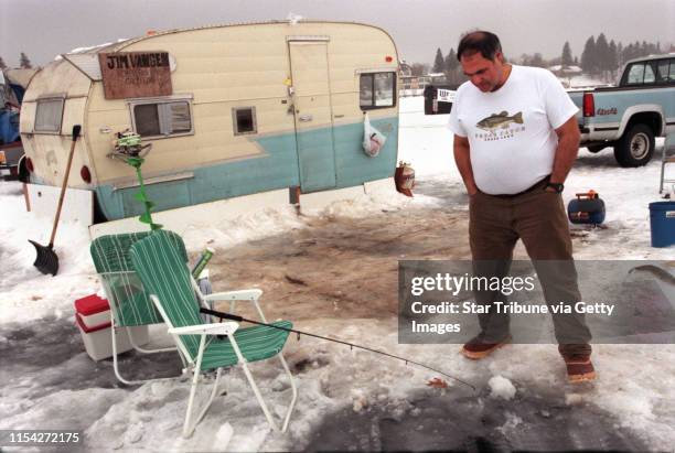 International Eelpout Festival in Walker, Mn. -- Jim Vangen from Cross Lake, Mn. Checks a line outside of the camper he and friends stayed in. There...