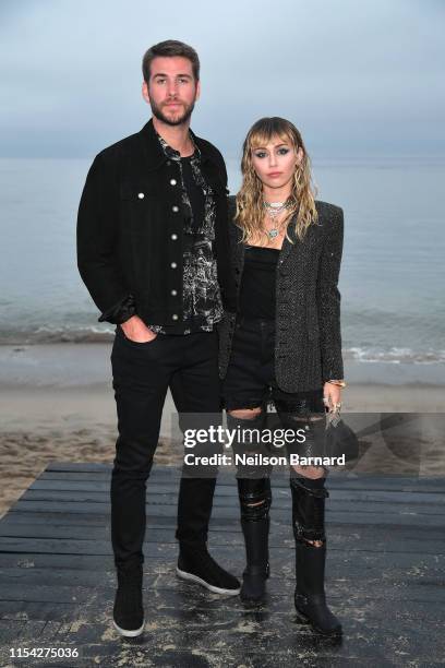 Liam Hemsworth and Miley Cyrus attend the Saint Laurent Mens Spring Summer 20 Show on June 06, 2019 in Paradise Cove Malibu, California.