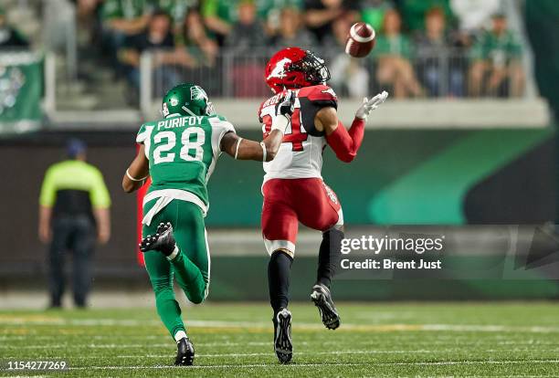 Reggie Begelton of the Calgary Stampeders hauls in a long pass for a touchdown against Loucheiz Purifoy of the Saskatchewan Roughriders in the game...