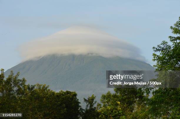 cloud or ufo - costa rica volcano stock pictures, royalty-free photos & images