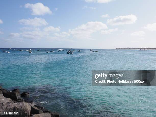 turquoise waters of atlantic ocean landscape and rocks at african town of santa maria on sal - sal stock pictures, royalty-free photos & images