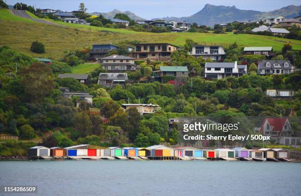 new zealand- view of the colorful akaroa boat houses - christchurch new zealand stock pictures, royalty-free photos & images