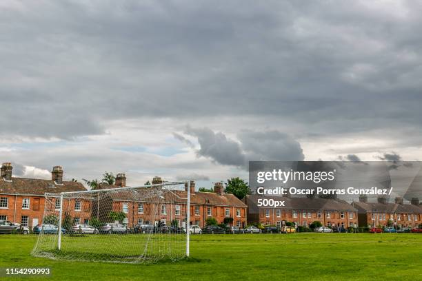 nice football field in england a cloudy day - muddy football pitch stock pictures, royalty-free photos & images