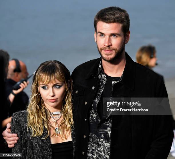 Miley Cyrus and Liam Hemsworth attend the Saint Laurent Mens Spring Summer 20 Show on June 06, 2019 in Paradise Cove Malibu, California.