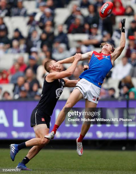 Jayden Hunt of the Demons and Liam Jones of the Blues compete for the ball during the 2019 AFL round 16 match between the Carlton Blues and the...