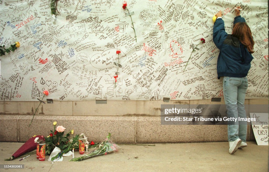 At the Denver Civic Center Amphitheater, at a candlelight vigil for victims of the Columbine HS shootings, Tamara Tatar writes her sentiments on a memory wall Wednesday, april 21. She is 18, and a senior at Ponderosa H.S. in Parker, Colorado. She is worri