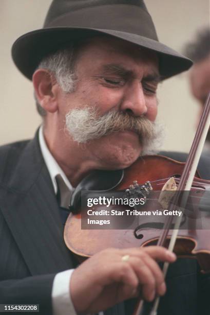 Chanov, Czech Republic. July 9, 1999. Roma Funeral. -- Mirek Rac teared up as he played a mournful tune on the violin during the funeral for a...