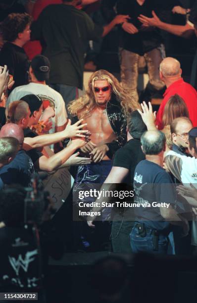 Summerslam wrestling with Gov. Ventura -- WWF wrestler Edge makes his way through the Target Center crowd and towards the ring to compete in the Tag...