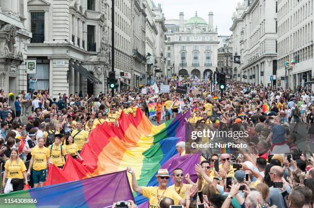 Flag bearers carry the rainbow flag during the Pride in London parade on 06 July, 2019 in London, England. The festival, which this year celebrates...