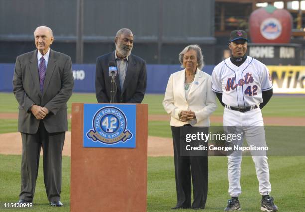 Ralph Branca, former Brooklyn Dodgers pitcher, David Robinson, Rachel Robinson and Willie Randolph, NY Mets Manager, stand at the podium on the field...