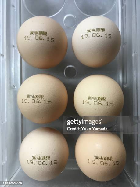 lights and shadows - chicken eggs with expiration date - best before stock pictures, royalty-free photos & images