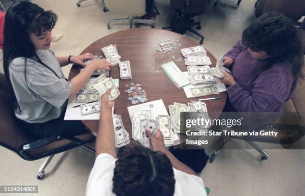 Goodwill/Easter Seals program trains welfare moms to be bank tellers. --L to R: Allison Lussier, Willona Hodges and Wendy Johnson practice closing...