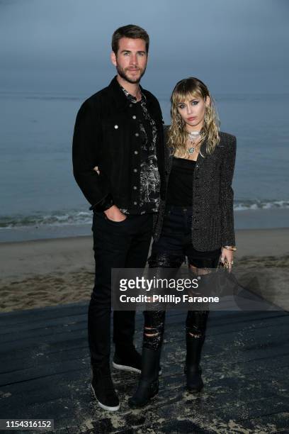 Liam Hemsworth and Miley Cyrus attend the Saint Laurent Mens Spring Summer 20 Show on June 6, 2019 in Malibu, California.